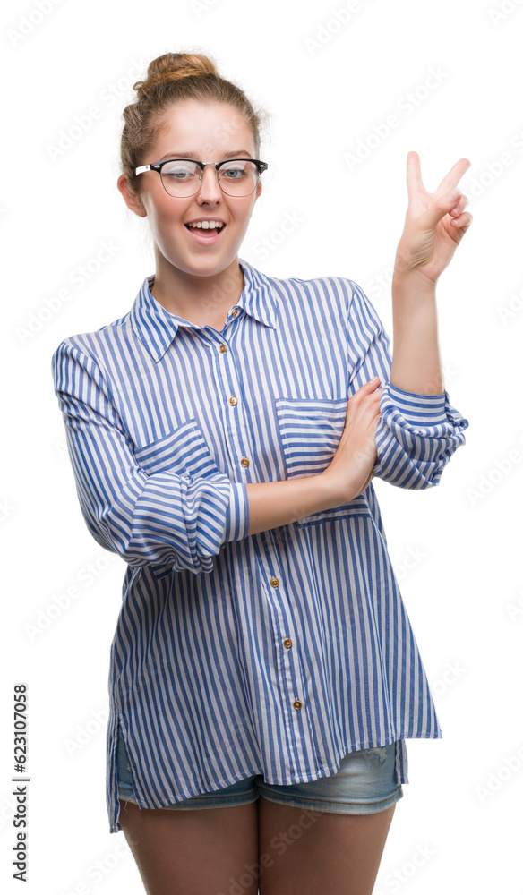 Young blonde business woman smiling with happy face winking at the camera doing victory sign. Number two. Young blonde business woman smiling with happy face winking at the camera doing victory sign. Number two.
