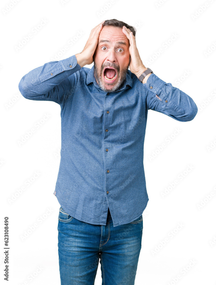 Handsome middle age elegant senior man over isolated background Crazy and scared with hands on head, afraid and surprised of shock with open mouth Handsome middle age elegant senior man over isolated background Crazy and scared with hands on head, afraid and surprised of shock with open mouth