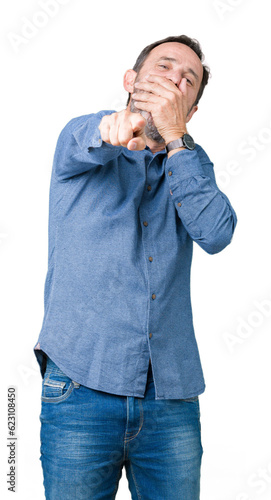 Handsome middle age elegant senior man over isolated background Laughing of you, pointing to the camera with finger hand over mouth, shame expression