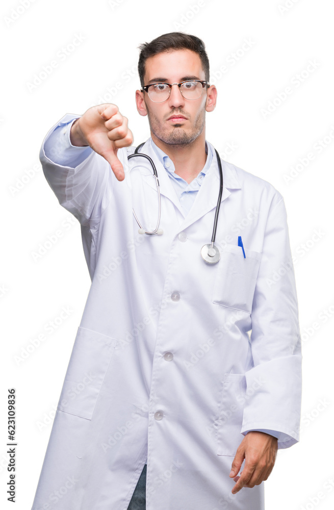 Handsome young doctor man looking unhappy and angry showing rejection and negative with thumbs down gesture. Bad expression. Handsome young doctor man looking unhappy and angry showing rejection and negative with thumbs down gesture. Bad expression.