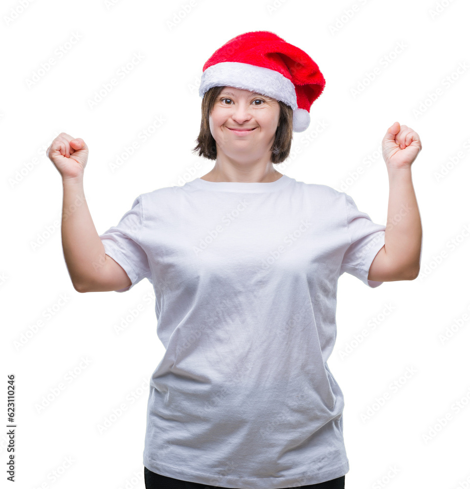 Young adult woman with down syndrome wearing christmas hat over isolated background celebrating mad and crazy for success with arms raised and closed eyes screaming excited. Winner concept Young adult woman with down syndrome wearing christmas hat over isolated background celebrating mad and crazy for success with arms raised and closed eyes screaming excited. Winner concept