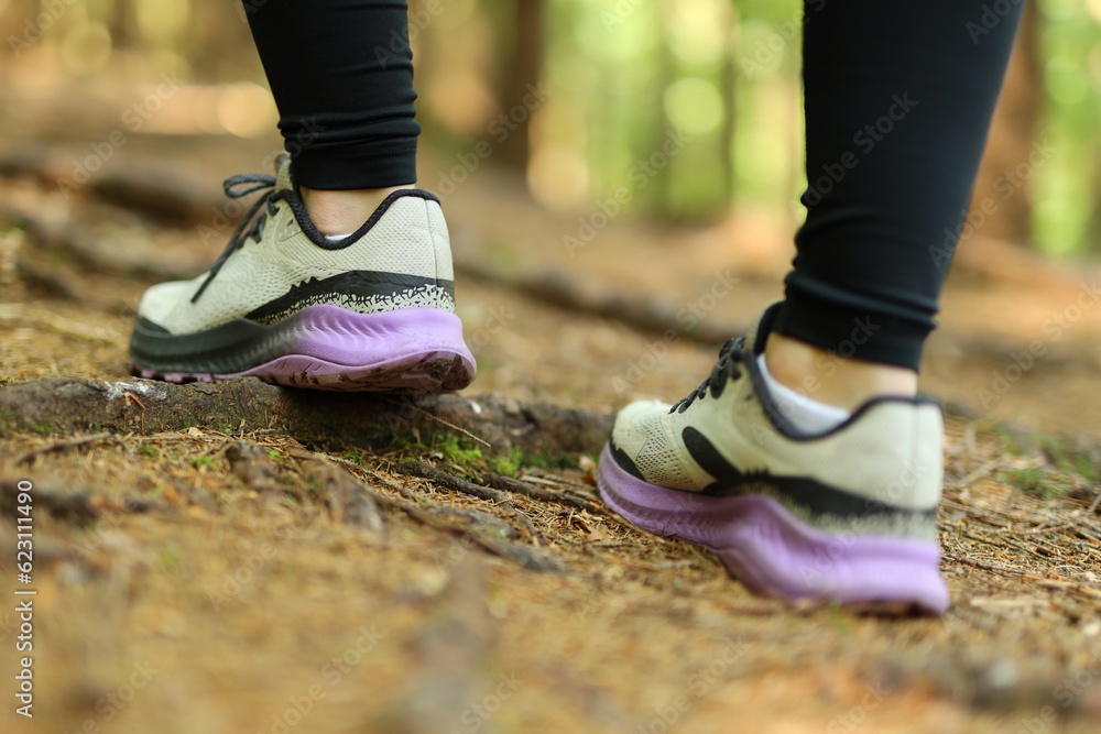 Close-up, athlete's feet on a forest path.