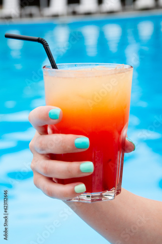 summer lifestyle at swimming pool. summer beach cocktail. summer vacation drink. drink cocktail at bar. refreshing alcoholic beverahe in glass. mixology and bartender