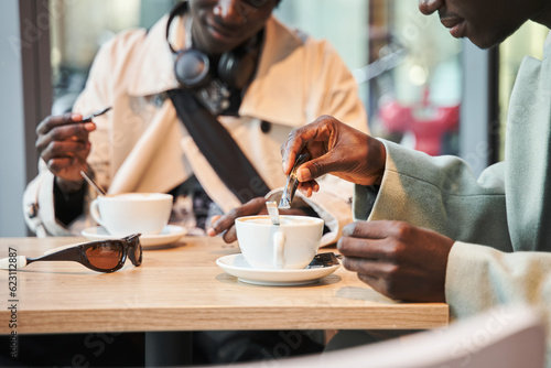 Close up cropped head portrait of multiracial men drinking coffee