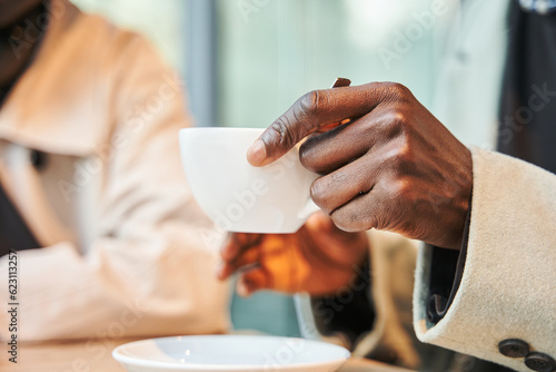 Close up cropped head portrait of multiracial men drinking coffee