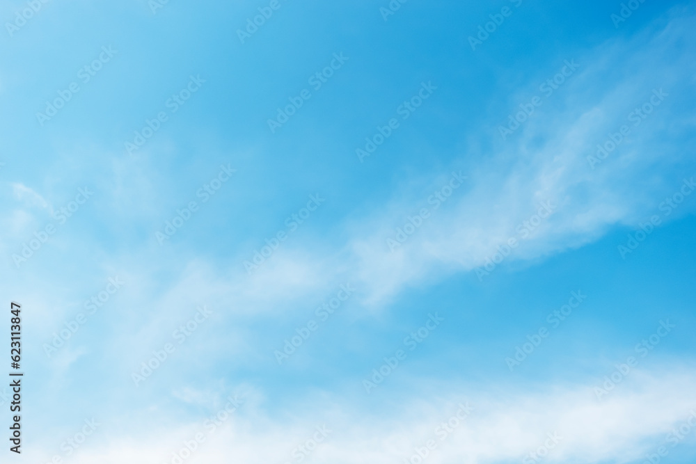 Blue sky background and white clouds soft focus, and copy space horizontal shape.