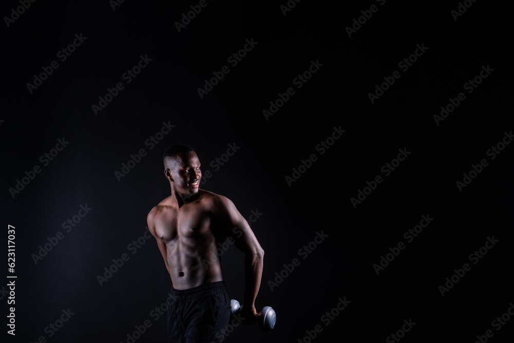 Portrait of an athletic african american man topless smiling, yellow, red and black background