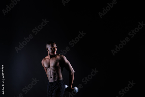 Portrait of an athletic african american man topless smiling, yellow, red and black background