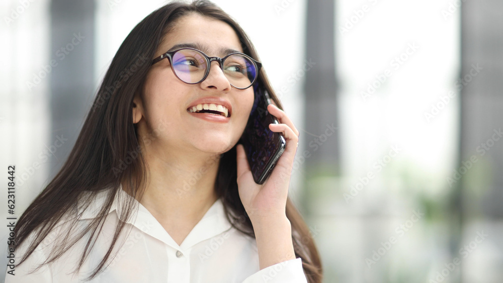 Informal Call. Young woman in glasses calling her friend, talking and asking about something Informal Call. Young woman in glasses calling her friend, talking and asking about something