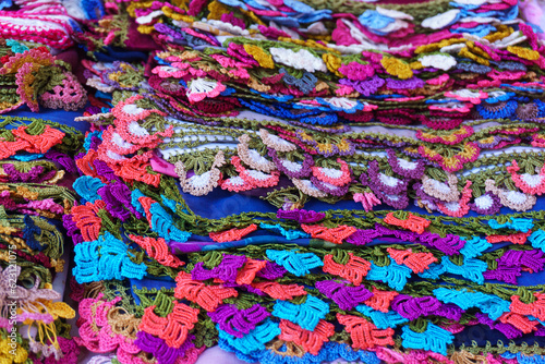 Stack of colorful crochet lace products in woman producer outdoor bazaar in Odemis, Izmir. Many or lots of different beautiful modern style needlework or handmade crochet laces. © Akin Ozcan