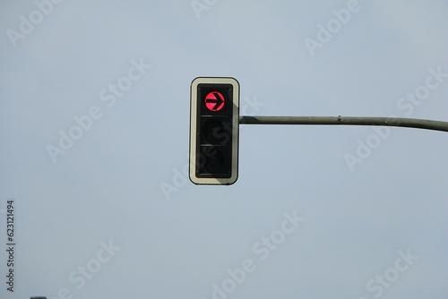 red right turn traffic light hanging on metal post