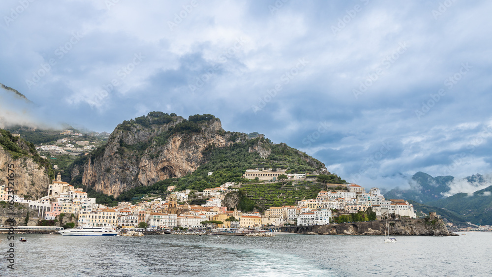Panorama view of Amalfi, a town in dramatic natural setting below steep cliffs on Italy's Southwest coast.