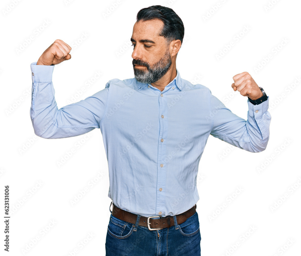 Middle aged man with beard wearing business shirt showing arms muscles smiling proud. fitness concept. Middle aged man with beard wearing business shirt showing arms muscles smiling proud. fitness concept.
