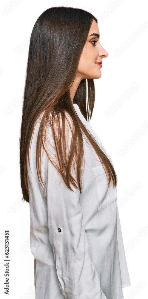 Young beautiful woman wearing casual white shirt looking to side, relax profile pose with natural face and confident smile. Young beautiful woman wearing casual white shirt looking to side, relax profile pose with natural face and confident smile.