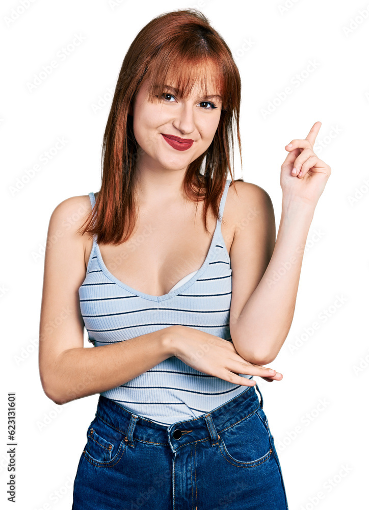 Redhead young woman wearing casual style with sleeveless shirt smiling happy pointing with hand and finger to the side Redhead young woman wearing casual style with sleeveless shirt smiling happy pointing with hand and finger to the side