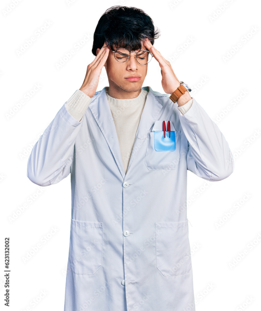 Handsome hipster young man wearing doctor uniform with hand on head, headache because stress. suffering migraine. Handsome hipster young man wearing doctor uniform with hand on head, headache because stress. suffering migraine.