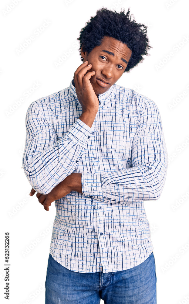 Handsome african american man with afro hair wearing casual clothes thinking looking tired and bored with depression problems with crossed arms. Handsome african american man with afro hair wearing casual clothes thinking looking tired and bored with depression problems with crossed arms.