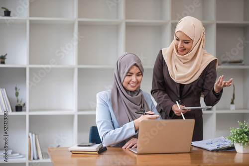 Professional Muslim business team working together, discussing on an important project in the office room. co-working concept