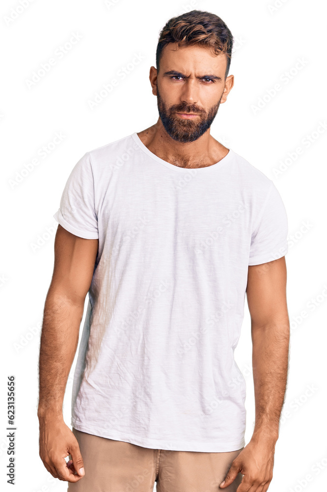 Young hispanic man wearing casual white tshirt skeptic and nervous, frowning upset because of problem. negative person. Young hispanic man wearing casual white tshirt skeptic and nervous, frowning upset because of problem. negative person.