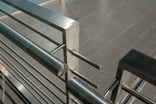 modern building balustrade, detail in polished and satin steel, the parapet protects from falling. Contemporary architecture. handrail geometry. photo
