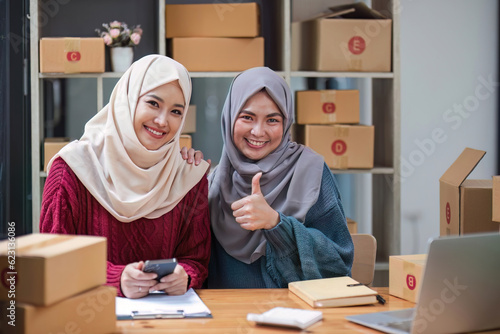 Young muslim online business team working together, showing a thumbs up sign. good job, excellent, awesome gesture