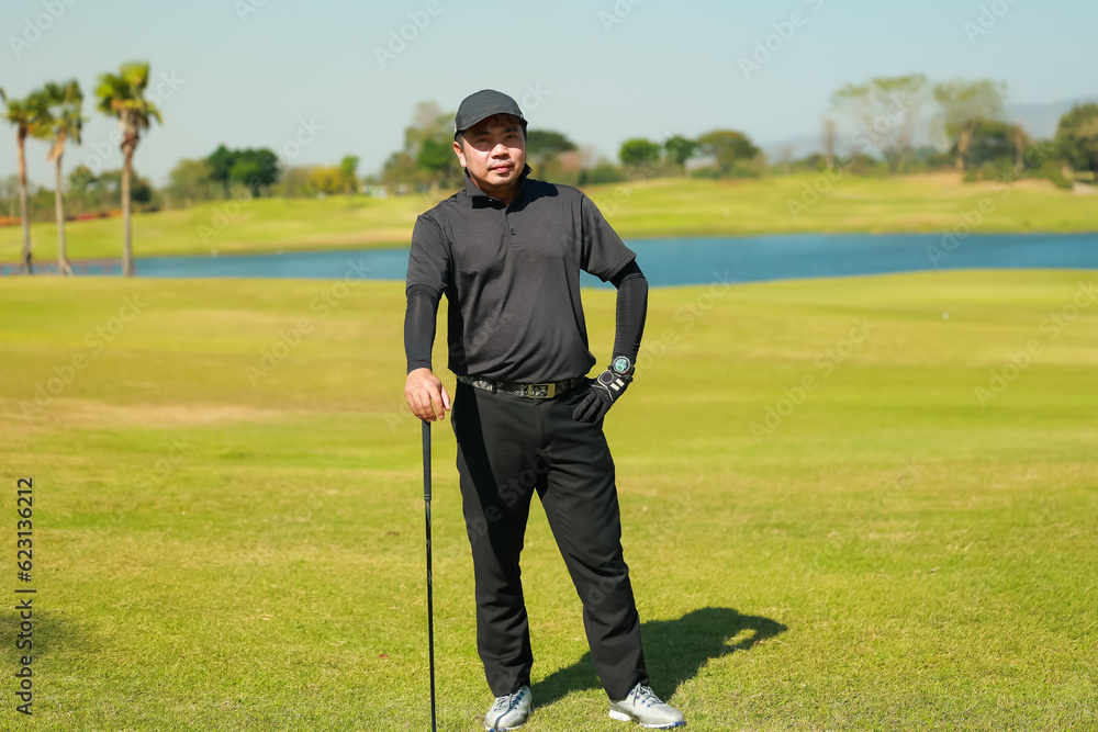 Portrait asian man professinal golf player on golf course. Pro golfer taking a shot