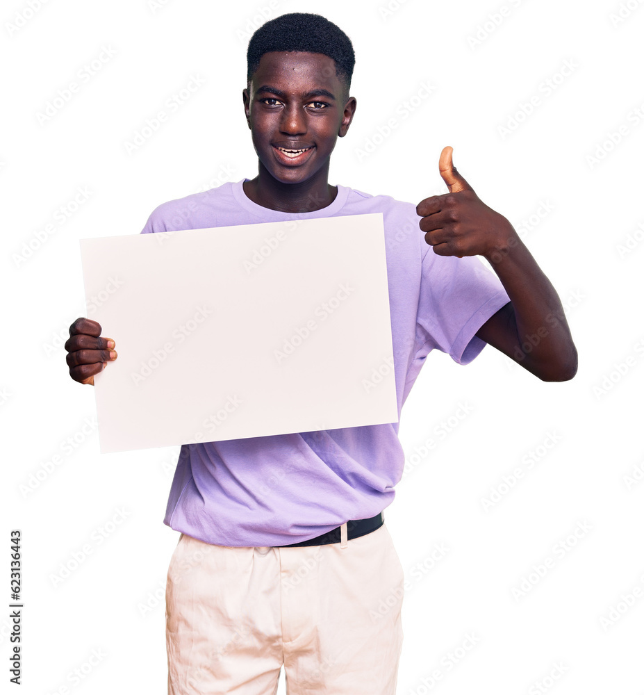 Young african american man holding blank empty banner smiling happy and positive, thumb up doing excellent and approval sign Young african american man holding blank empty banner smiling happy and positive, thumb up doing excellent and approval sign