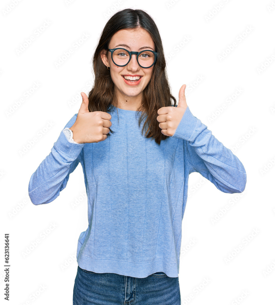 Young beautiful woman wearing casual clothes and glasses success sign doing positive gesture with hand, thumbs up smiling and happy. cheerful expression and winner gesture. Young beautiful woman wearing casual clothes and glasses success sign doing positive gesture with hand, thumbs up smiling and happy. cheerful expression and winner gesture.