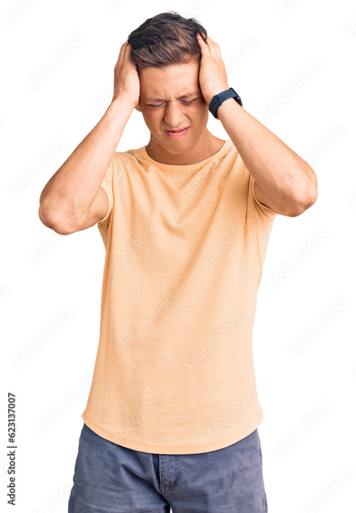 Young handsome man wearing casual clothes suffering from headache desperate and stressed because pain and migraine. hands on head. Young handsome man wearing casual clothes suffering from headache desperate and stressed because pain and migraine. hands on head.