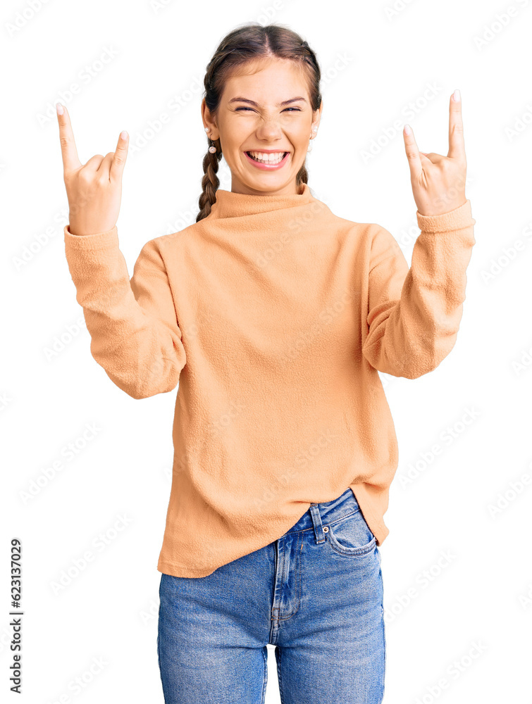 Beautiful caucasian woman with blonde hair wearing casual winter sweater shouting with crazy expression doing rock symbol with hands up. music star. heavy concept. Beautiful caucasian woman with blonde hair wearing casual winter sweater shouting with crazy expression doing rock symbol with hands up. music star. heavy concept.