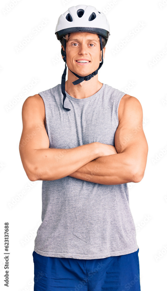 Young handsome man wearing bike helmet happy face smiling with crossed arms looking at the camera. positive person. Young handsome man wearing bike helmet happy face smiling with crossed arms looking at the camera. positive person.