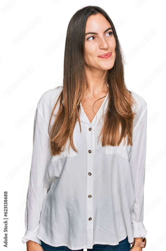 Young beautiful woman wearing casual clothes smiling looking to the side and staring away thinking. Young beautiful woman wearing casual clothes smiling looking to the side and staring away thinking.