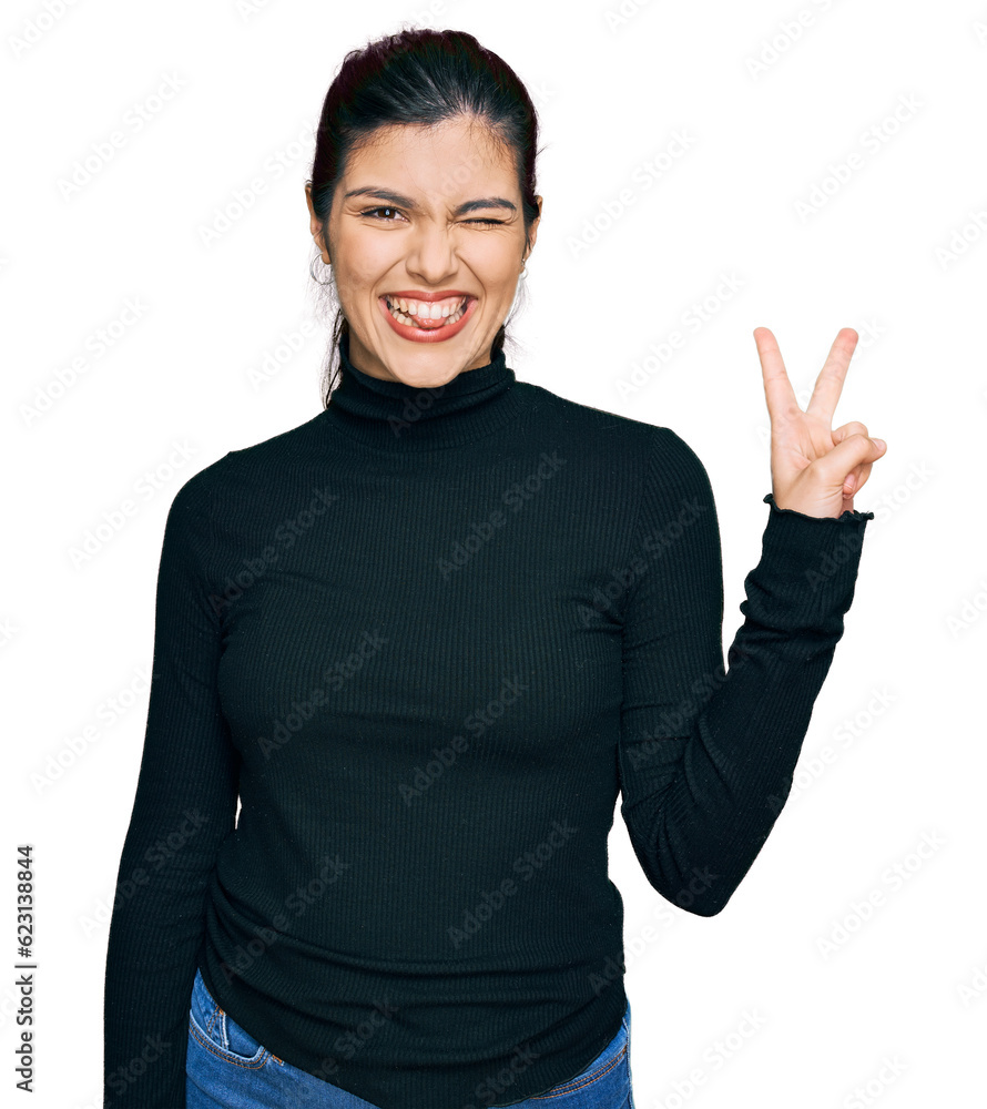 Young hispanic woman wearing casual clothes smiling with happy face winking at the camera doing victory sign. number two. Young hispanic woman wearing casual clothes smiling with happy face winking at the camera doing victory sign. number two.