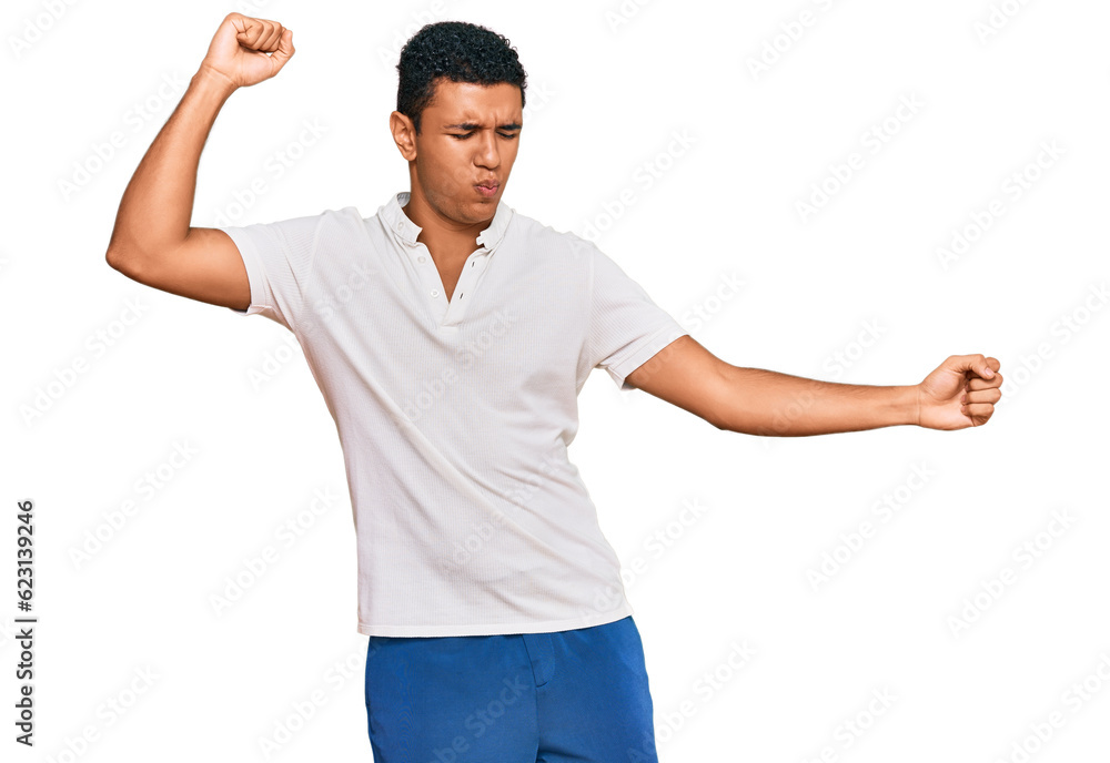 Young arab man wearing casual clothes dancing happy and cheerful, smiling moving casual and confident listening to music Young arab man wearing casual clothes dancing happy and cheerful, smiling moving casual and confident listening to music