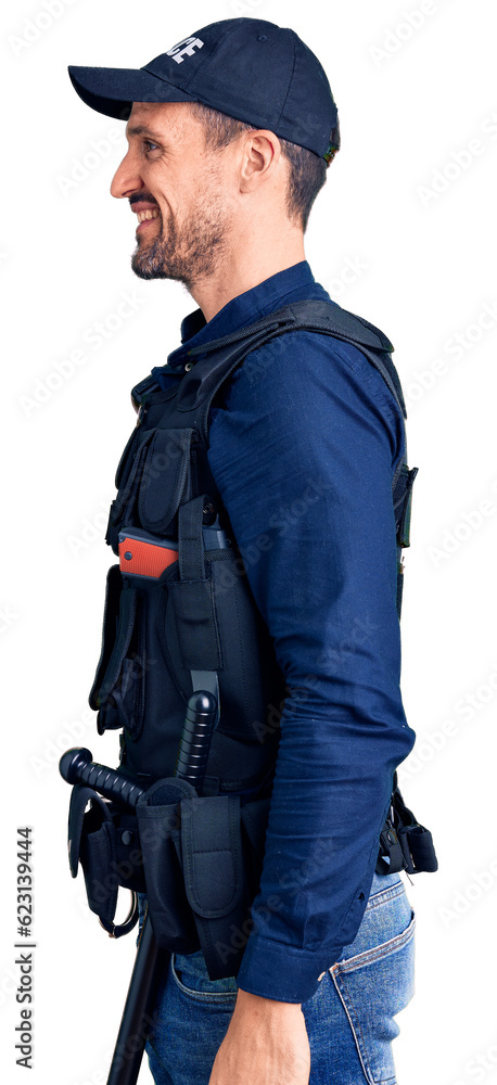 Young handsome man wearing police uniform looking to side, relax profile pose with natural face and confident smile. Young handsome man wearing police uniform looking to side, relax profile pose with natural face and confident smile.