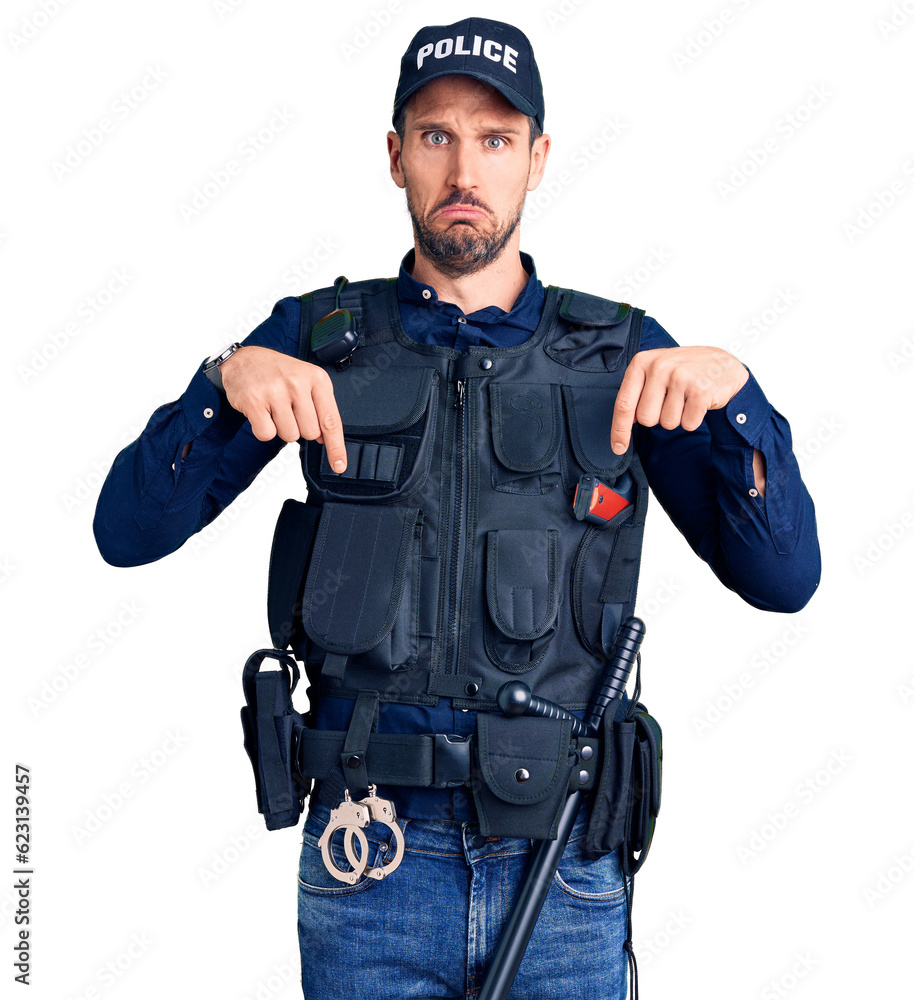 Young handsome man wearing police uniform pointing down looking sad and upset, indicating direction with fingers, unhappy and depressed. Young handsome man wearing police uniform pointing down looking sad and upset, indicating direction with fingers, unhappy and depressed.