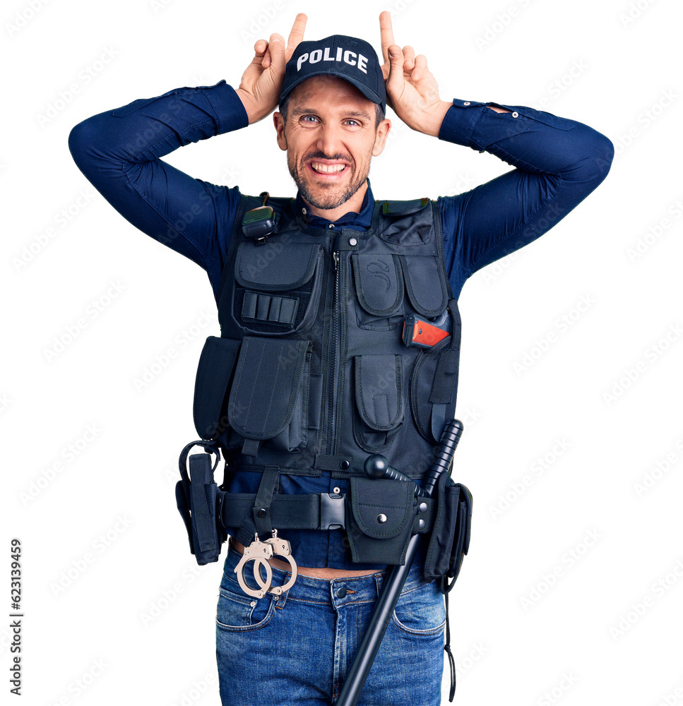 Young handsome man wearing police uniform posing funny and crazy with fingers on head as bunny ears, smiling cheerful Young handsome man wearing police uniform posing funny and crazy with fingers on head as bunny ears, smiling cheerful