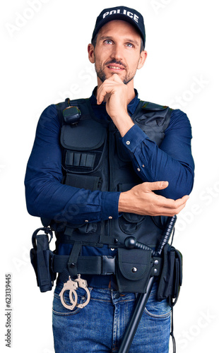 Young handsome man wearing police uniform with hand on chin thinking about question, pensive expression. smiling and thoughtful face. doubt concept.