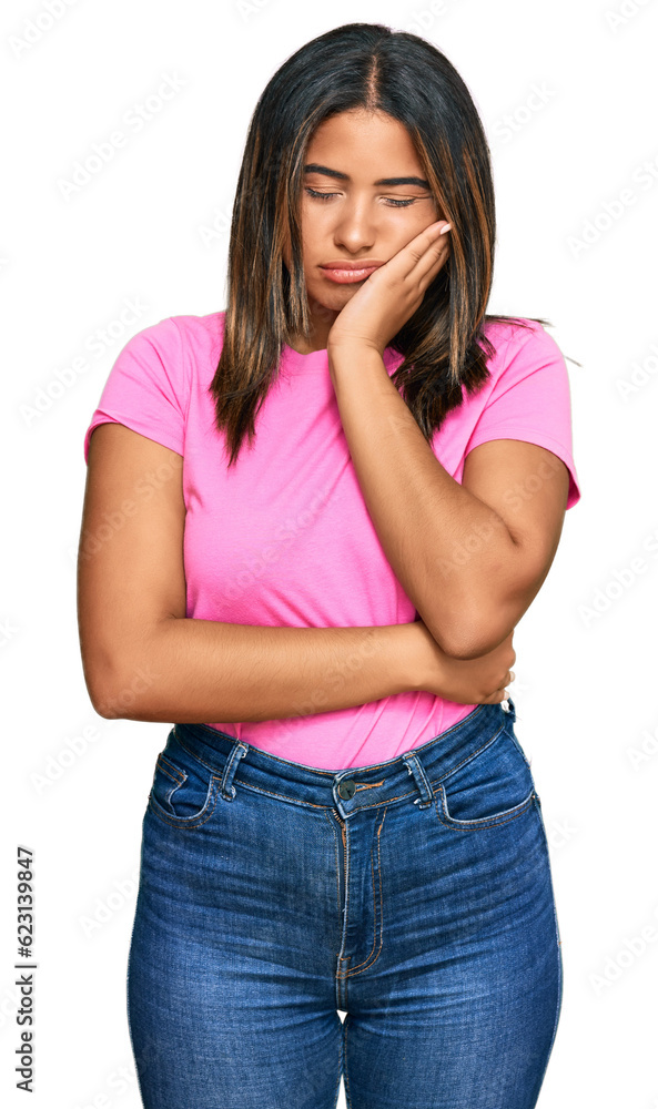 Young latin girl wearing casual clothes thinking looking tired and bored with depression problems with crossed arms. Young latin girl wearing casual clothes thinking looking tired and bored with depression problems with crossed arms.