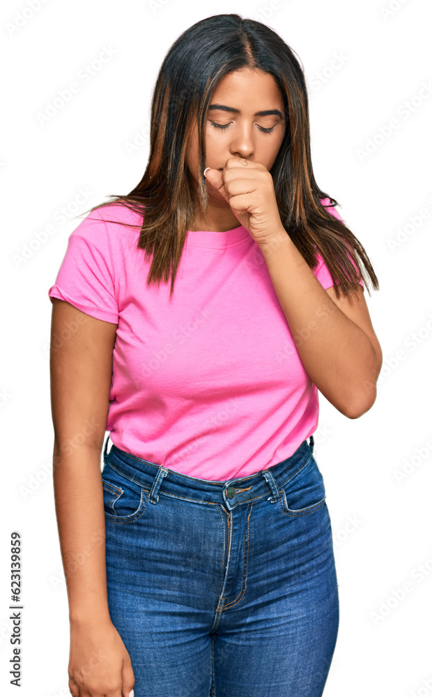 Young latin girl wearing casual clothes feeling unwell and coughing as symptom for cold or bronchitis. health care concept. Young latin girl wearing casual clothes feeling unwell and coughing as symptom for cold or bronchitis. health care concept.