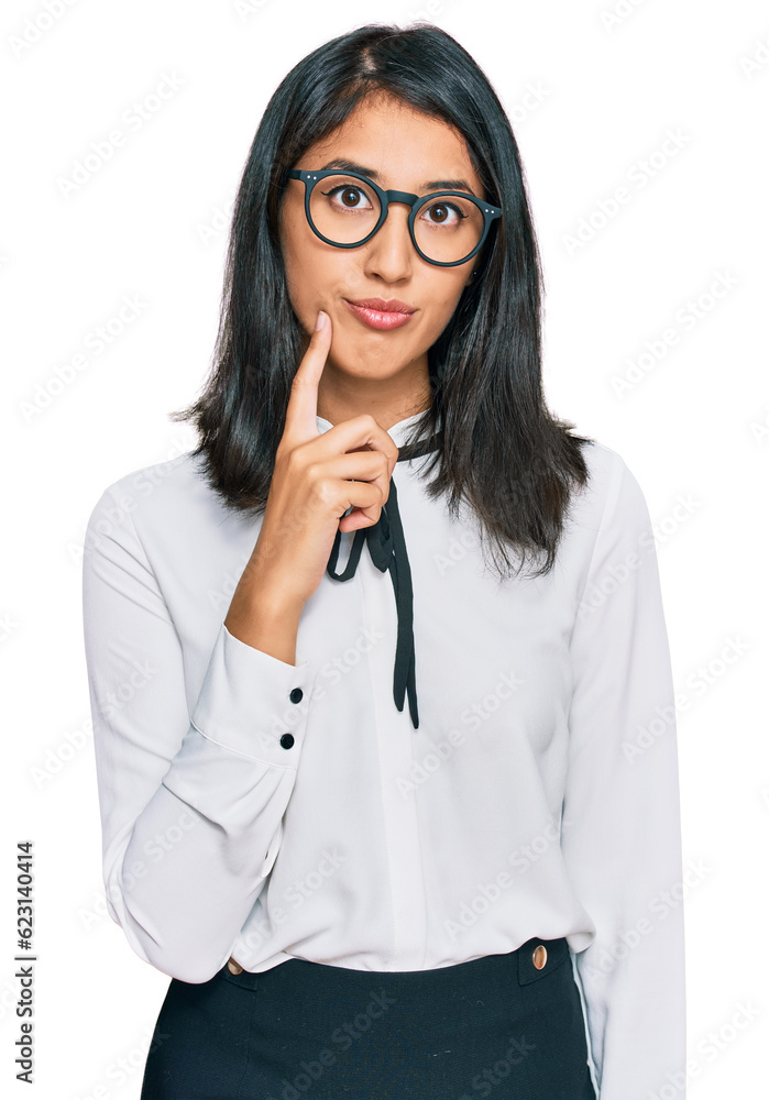 Beautiful asian young woman wearing business shirt and glasses serious face thinking about question with hand on chin, thoughtful about confusing idea Beautiful asian young woman wearing business shirt and glasses serious face thinking about question with hand on chin, thoughtful about confusing idea