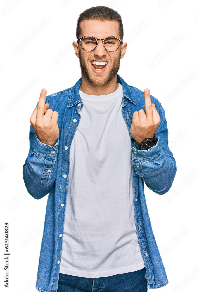Young caucasian man wearing casual clothes showing middle finger doing fuck you bad expression, provocation and rude attitude. screaming excited Young caucasian man wearing casual clothes showing middle finger doing fuck you bad expression, provocation and rude attitude. screaming excited