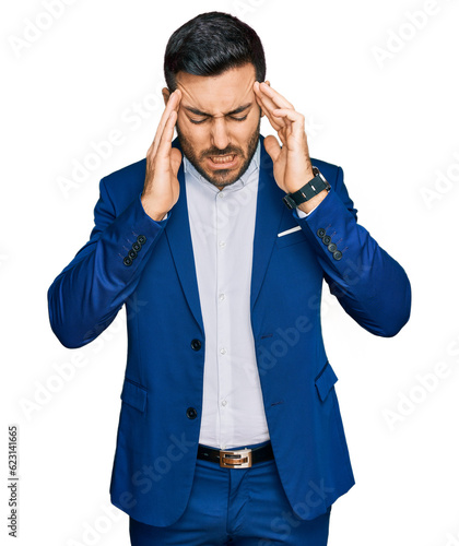 Obraz na plátně Young hispanic man wearing business jacket with hand on head, headache because stress