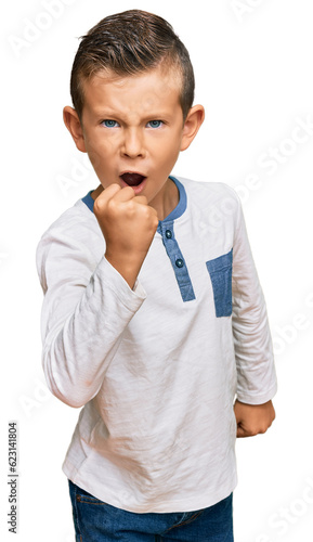 Fotografie Adorable caucasian kid wearing casual clothes angry and mad raising fist frustrated and furious while shouting with anger