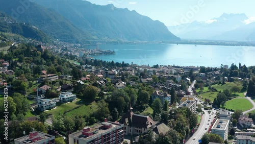 Aerial flight over city of Montreux towards Lake Geneva.Switzerland. The mountains of the Alps in the background.