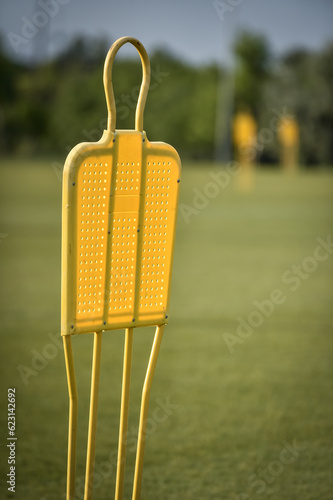 Yellow soccer dummie used for dribble training on a football field photo