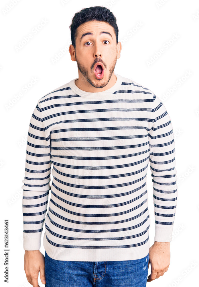 Young hispanic man wearing casual clothes afraid and shocked with surprise and amazed expression, fear and excited face. Young hispanic man wearing casual clothes afraid and shocked with surprise and amazed expression, fear and excited face.