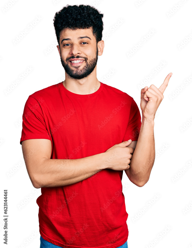 Young arab man with beard wearing casual red t shirt with a big smile on face, pointing with hand and finger to the side looking at the camera. Young arab man with beard wearing casual red t shirt with a big smile on face, pointing with hand and finger to the side looking at the camera.
