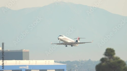 Generic Unmarked Private Executive Business Charter Jet Taking Off from a Los Angeles CA Area Airport into a Blue Sky on a Sunny Day in California