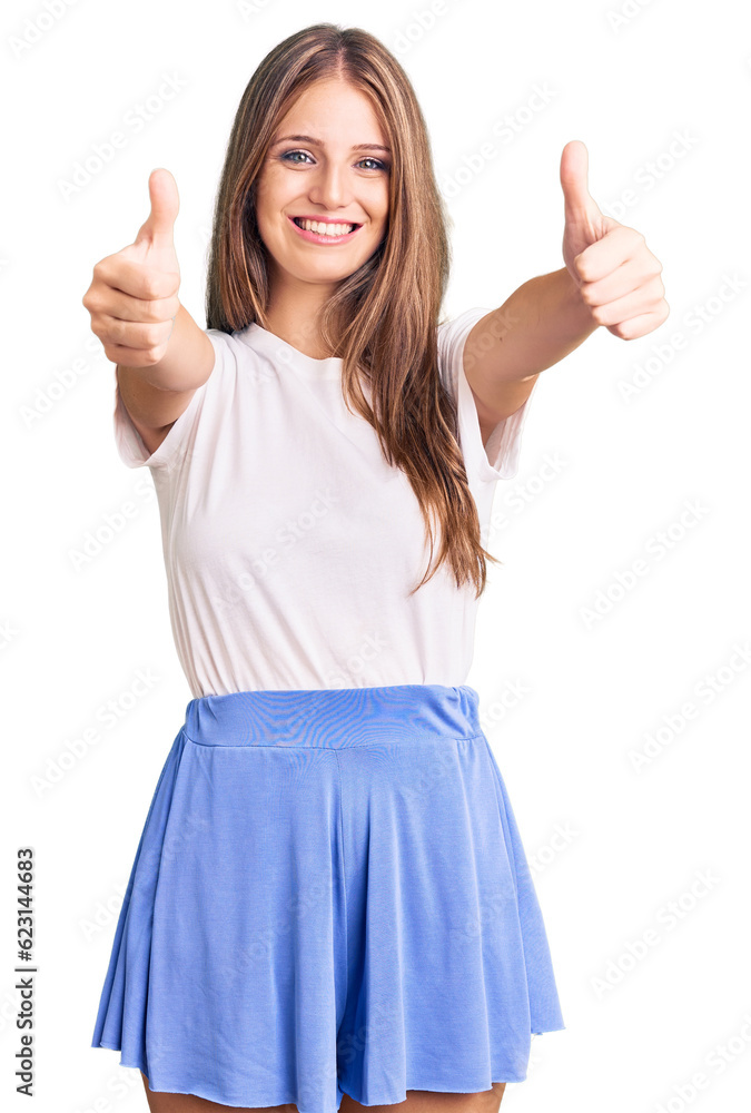 Young beautiful blonde woman wearing summer style approving doing positive gesture with hand, thumbs up smiling and happy for success. winner gesture. Young beautiful blonde woman wearing summer style approving doing positive gesture with hand, thumbs up smiling and happy for success. winner gesture.